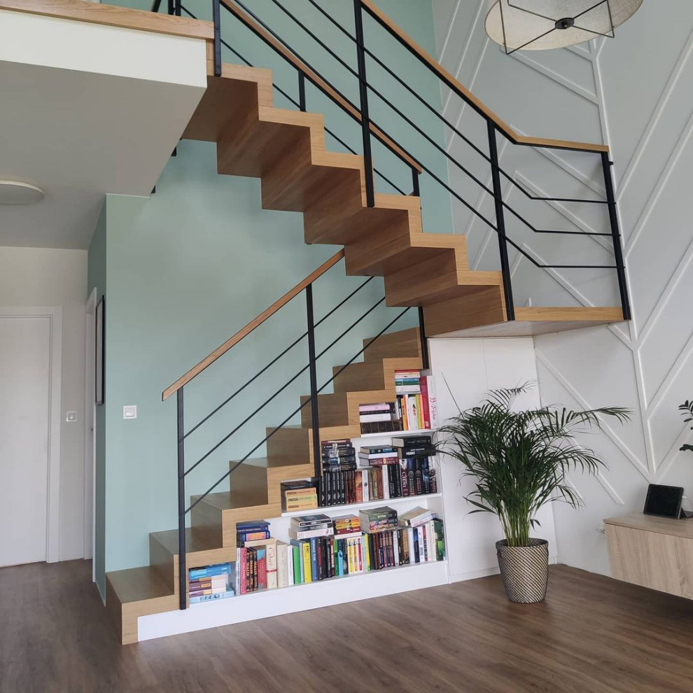 Photo of a medium sized modern wood u-shaped wire cable railing staircase in Moscow with wood risers.
