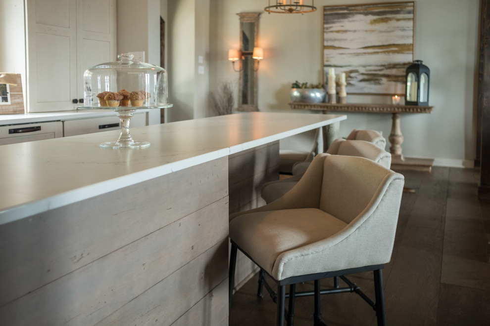 Example of a large transitional galley dark wood floor and brown floor open concept kitchen design with a farmhouse sink, shaker cabinets, quartz countertops, brown backsplash, brick backsplash, stainless steel appliances and an island