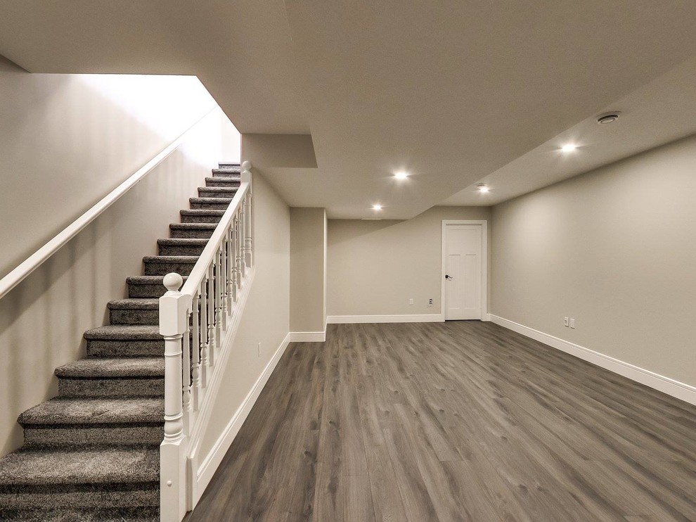 Inspiration for a mid-sized transitional carpeted straight staircase in Edmonton with carpet risers and wood railing.
