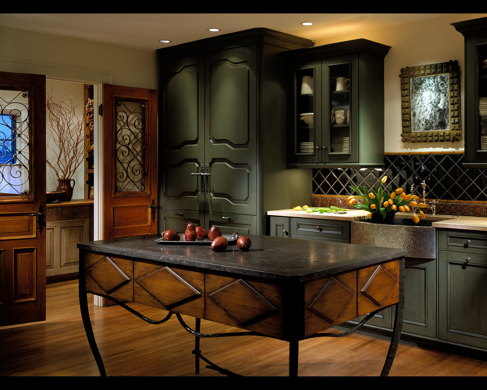 Large mountain style l-shaped medium tone wood floor kitchen pantry photo in Chicago with a farmhouse sink, recessed-panel cabinets, green cabinets, multicolored backsplash, stone tile backsplash, paneled appliances and an island