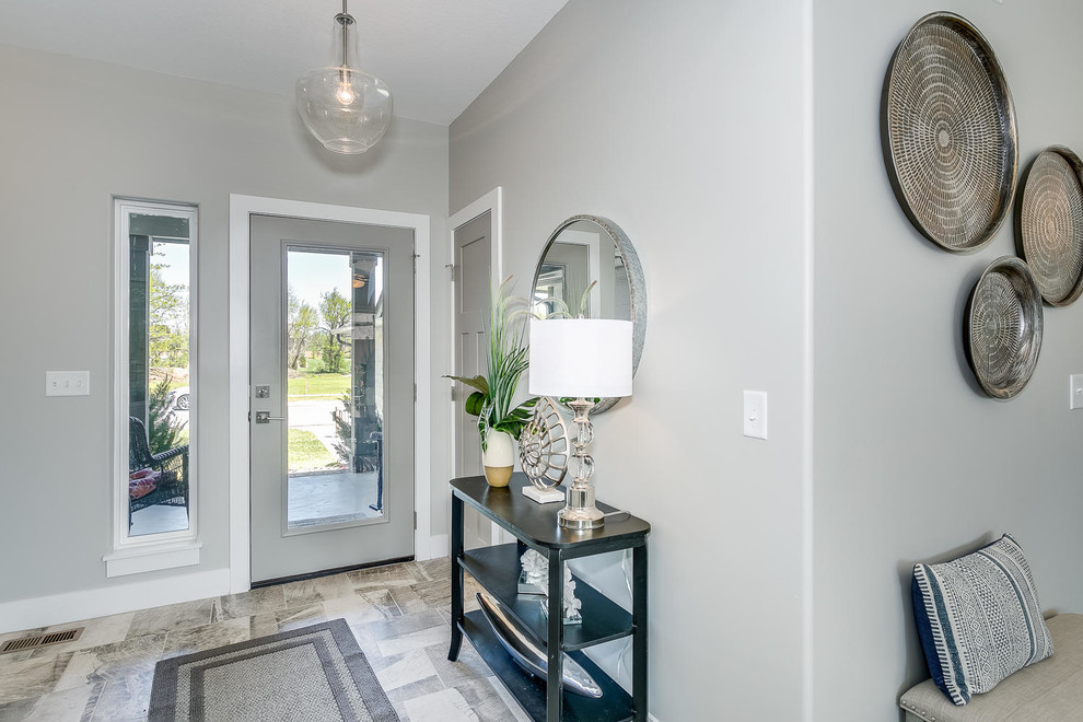 Photo of a small contemporary front door in Wichita with grey walls, ceramic floors, a single front door, a gray front door and grey floor.