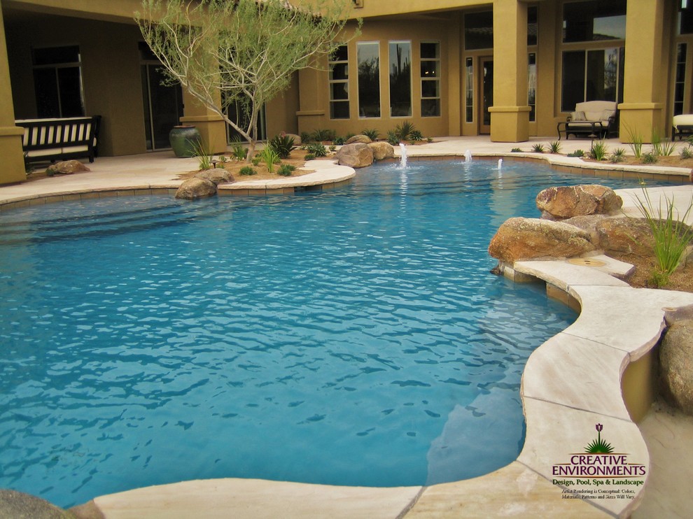 Inspiration for a large backyard stamped concrete and custom-shaped hot tub remodel in Phoenix