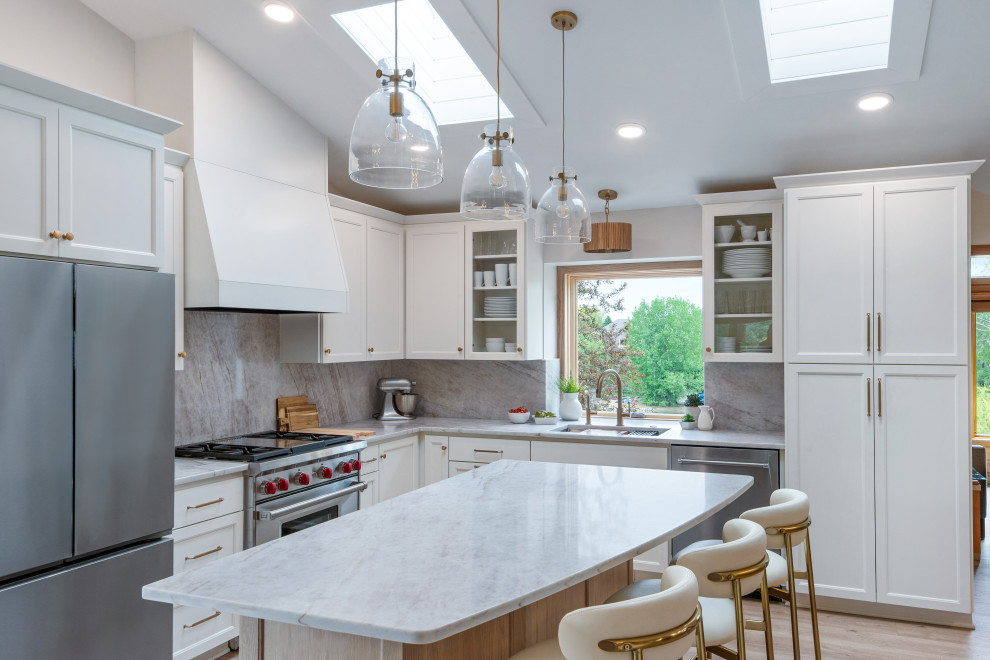 Inspiration for a transitional l-shaped vaulted ceiling kitchen remodel in Minneapolis with white cabinets, an island and white countertops