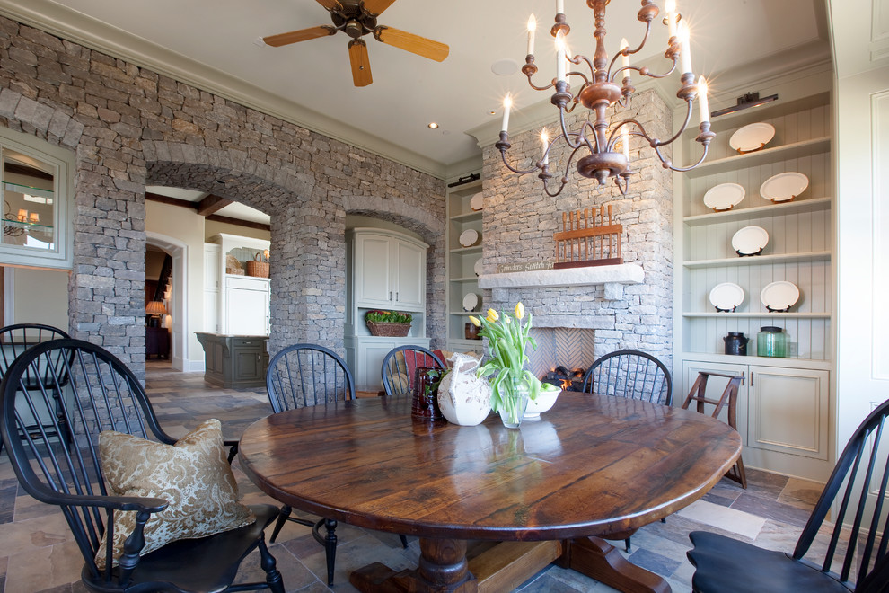 This is an example of a traditional separate dining room in Nashville with a standard fireplace and a stone fireplace surround.