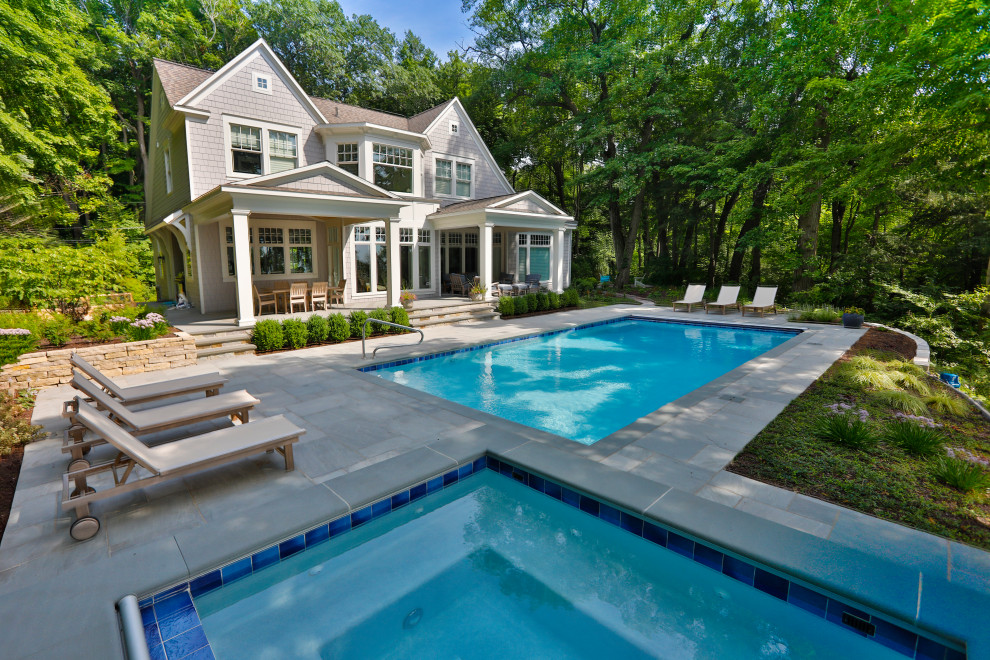 Ispirazione per una piscina monocorsia chic rettangolare di medie dimensioni e dietro casa con pavimentazioni in pietra naturale