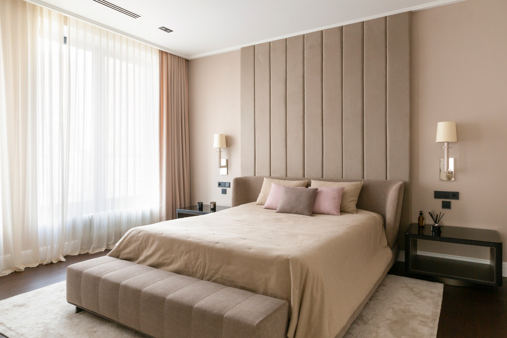 Photo of a modern bedroom in Moscow with beige walls, dark hardwood floors and brown floor.