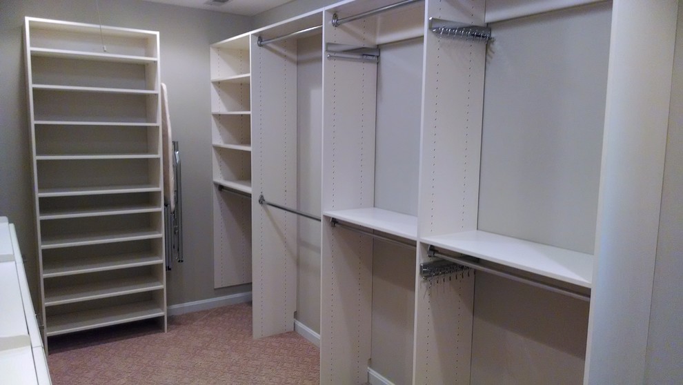 Design ideas for a mid-sized transitional gender-neutral walk-in wardrobe in Baltimore with raised-panel cabinets, white cabinets and carpet.