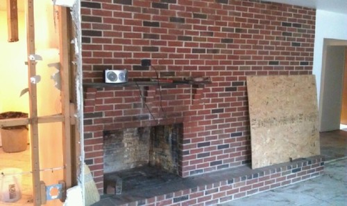 Fireplace off center for starters and just unsightly . Needs a make over.