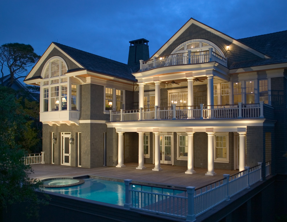 Mid-sized beach style three-storey green exterior in Charleston with wood siding.