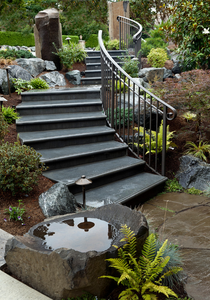 Inspiration for a large traditional concrete curved staircase in Seattle with metal railing.