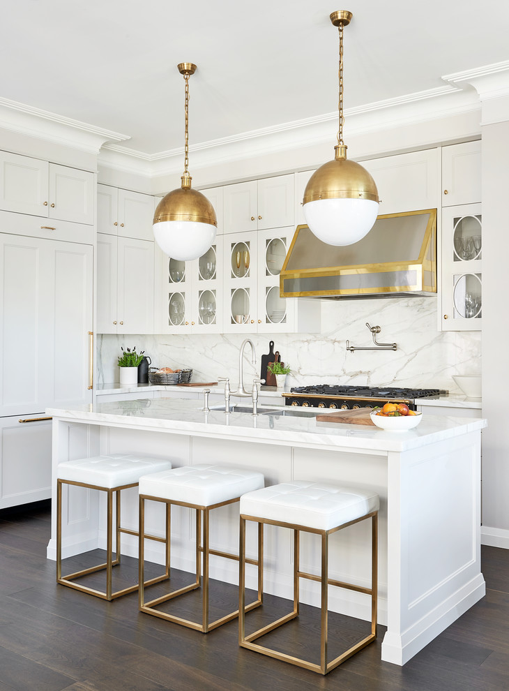 Design ideas for a transitional l-shaped kitchen in Toronto with a double-bowl sink, recessed-panel cabinets, white cabinets, white splashback, panelled appliances, dark hardwood floors, with island, brown floor and white benchtop.