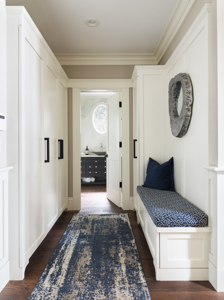 Inspiration for a mid-sized coastal dark wood floor and brown floor hallway remodel in Boston with beige walls