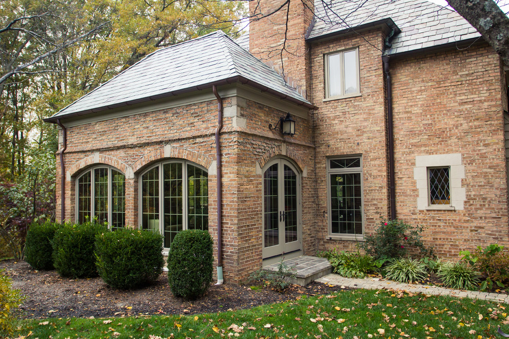 Design ideas for a large transitional two-storey brick red exterior in Cincinnati with a gable roof.