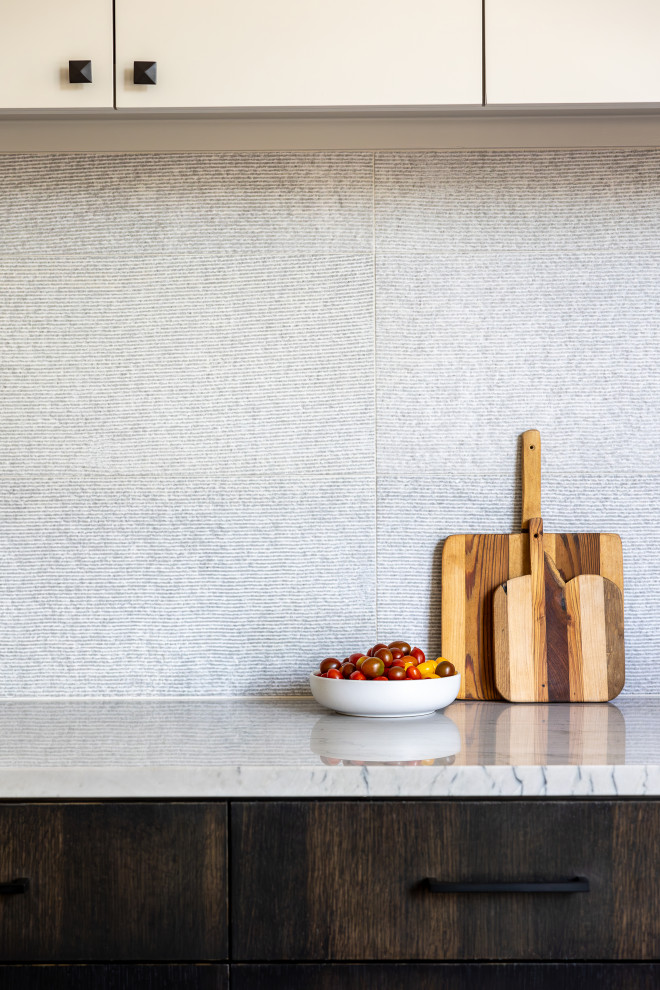 Example of a transitional kitchen design in Austin with dark wood cabinets, gray backsplash and stone tile backsplash