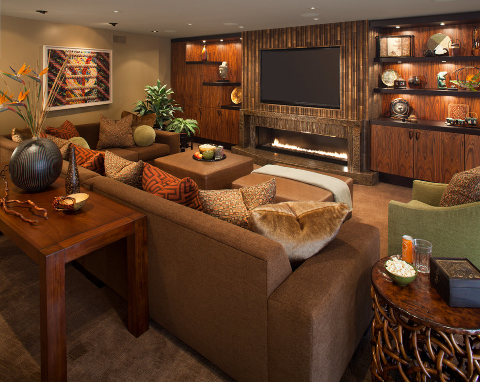 Photo of a large tropical open concept family room in San Diego with brown walls, carpet, a ribbon fireplace, a tile fireplace surround, a built-in media wall and brown floor.