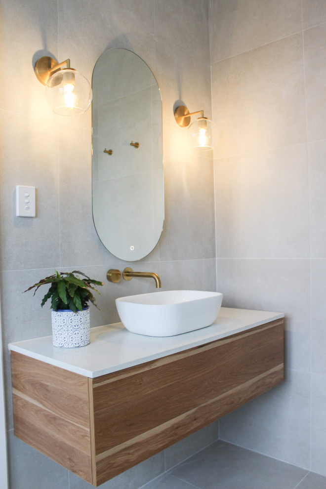 Large trendy master white tile and ceramic tile porcelain tile, gray floor and single-sink bathroom photo in Perth with flat-panel cabinets, dark wood cabinets, an undermount tub, a one-piece toilet, white walls, a vessel sink, quartz countertops, white countertops and a floating vanity