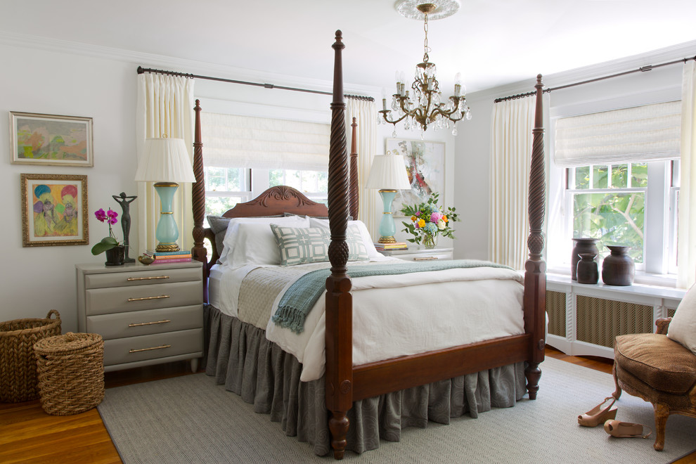 Mid-sized traditional master bedroom in St Louis with white walls and medium hardwood floors.