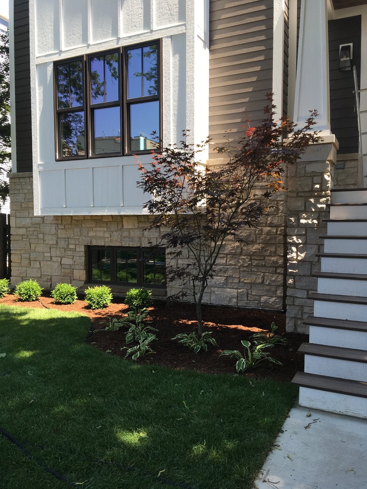 Large transitional two-story mixed siding brown home design photo in Chicago with a shingle roof