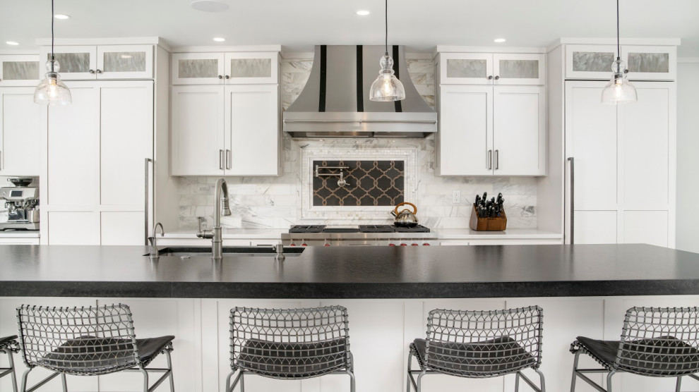 Example of a huge single-wall porcelain tile and white floor eat-in kitchen design with an undermount sink, shaker cabinets, white cabinets, granite countertops, white backsplash, ceramic backsplash, stainless steel appliances, two islands and black countertops