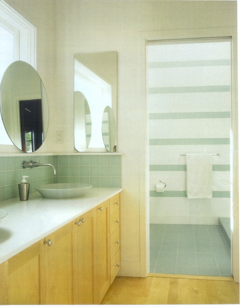 This is an example of a contemporary bathroom in San Francisco with solid surface benchtops and a vessel sink.