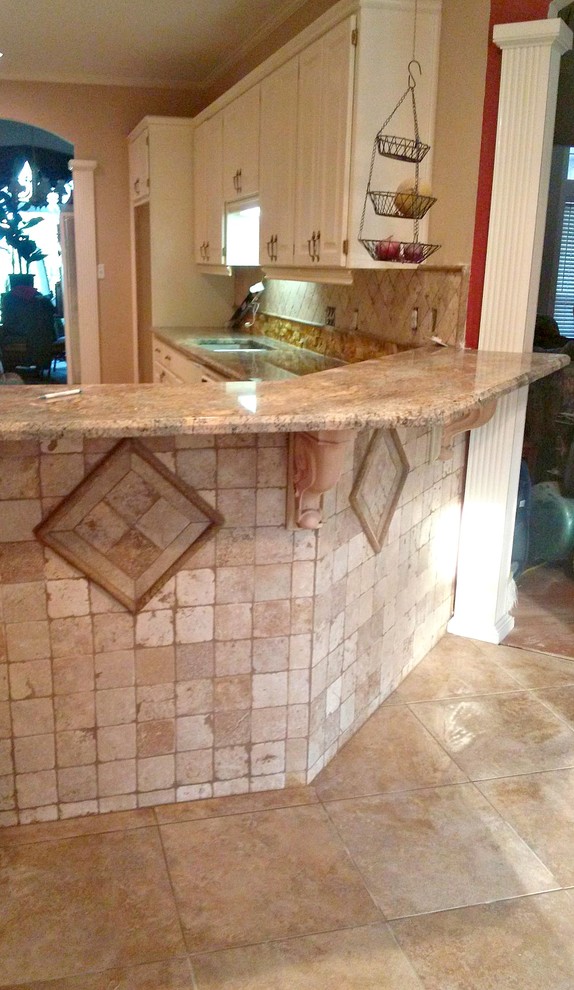 Example of a large transitional l-shaped ceramic tile and beige floor open concept kitchen design in Austin with a double-bowl sink, raised-panel cabinets, white cabinets, granite countertops, beige backsplash, ceramic backsplash and a peninsula