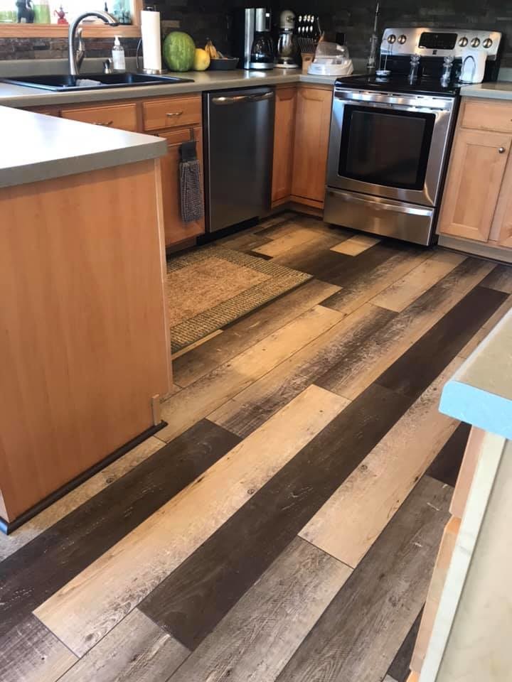 Mid-sized transitional vinyl floor and multicolored floor kitchen photo with a drop-in sink, flat-panel cabinets, light wood cabinets, laminate countertops, stone tile backsplash and stainless steel appliances