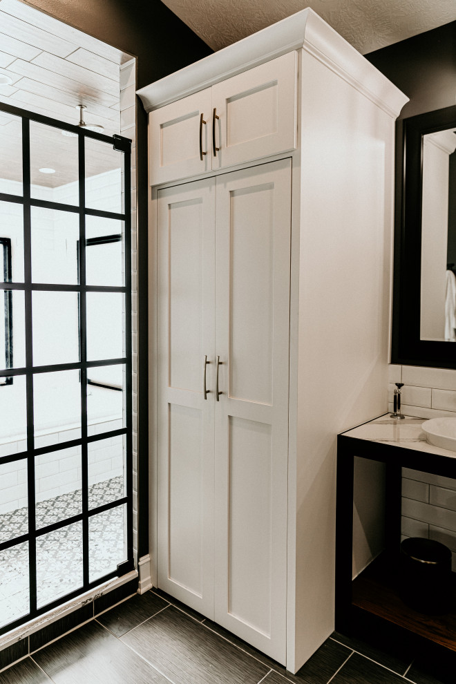 Photo of a mid-sized country master bathroom in Other with open cabinets, black cabinets, a drop-in tub, a double shower, white tile, subway tile, beige walls, ceramic floors, a vessel sink, engineered quartz benchtops, grey floor, a hinged shower door and white benchtops.
