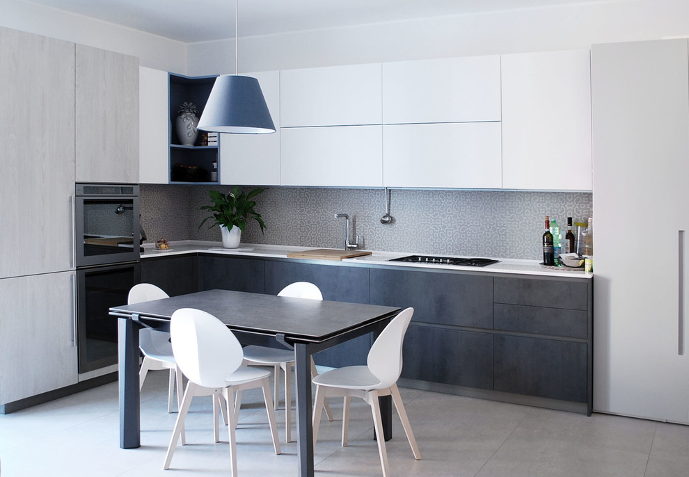Inspiration for a contemporary l-shaped open plan kitchen in Milan with an undermount sink, flat-panel cabinets, grey cabinets, quartz benchtops, beige splashback, porcelain splashback, stainless steel appliances, limestone floors and beige floor.