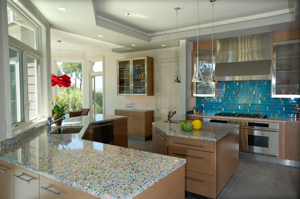 Photo of a contemporary kitchen in San Francisco with recycled glass benchtops, stainless steel appliances, flat-panel cabinets, medium wood cabinets and multi-coloured benchtop.