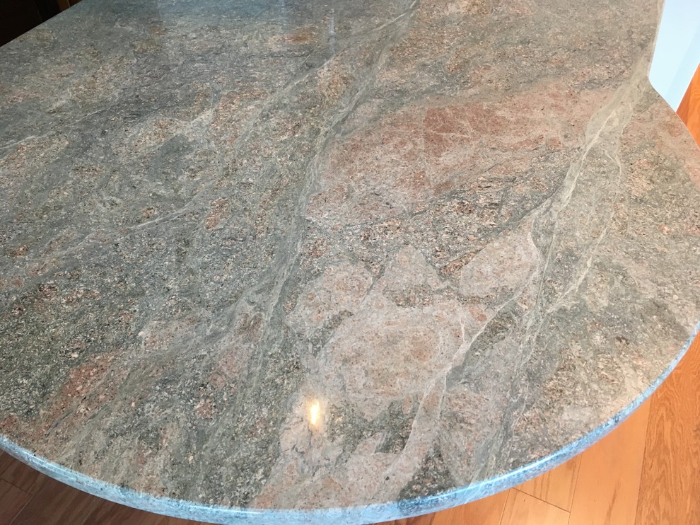 Example of a transitional u-shaped medium tone wood floor kitchen design in Boston with a drop-in sink, raised-panel cabinets, white cabinets, granite countertops, green backsplash, glass tile backsplash, white appliances, a peninsula and green countertops