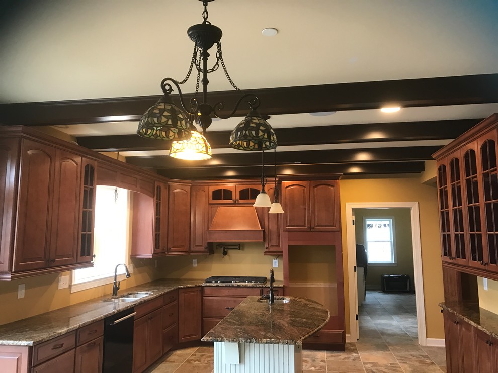 Inspiration for a large traditional u-shaped eat-in kitchen in Baltimore with a double-bowl sink, beaded inset cabinets, medium wood cabinets, granite benchtops, yellow splashback, black appliances, cement tiles, with island and multi-coloured floor.