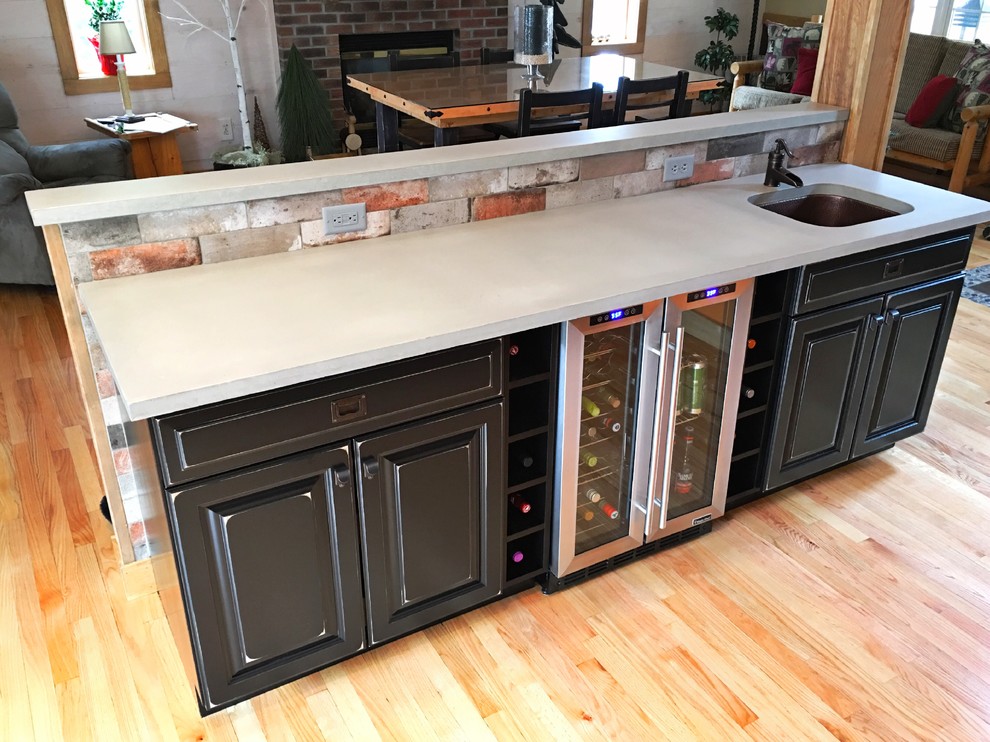 Inspiration for a rustic kitchen remodel in New York with concrete countertops and brick backsplash