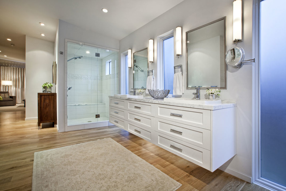 This is an example of a contemporary bathroom in Denver with a vessel sink, shaker cabinets, white cabinets, an alcove shower, white tile, quartzite benchtops and porcelain tile.