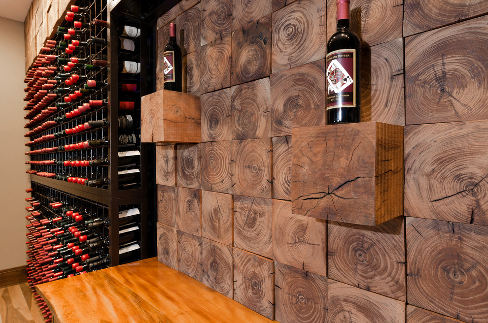 Large country wine cellar in Other with light hardwood floors and storage racks.