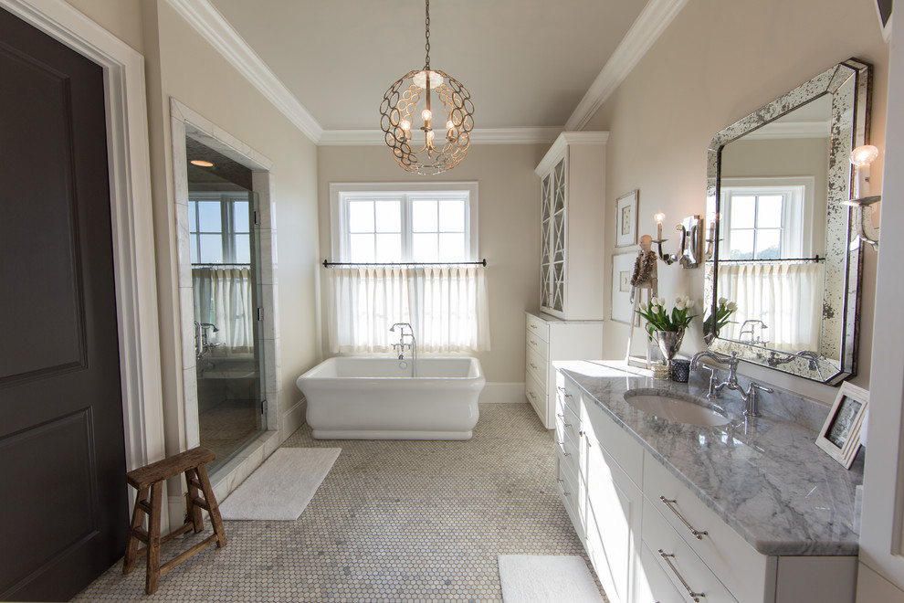 Large transitional master bathroom in Other with raised-panel cabinets, white cabinets, a freestanding tub, an alcove shower, beige walls, mosaic tile floors, an undermount sink, marble benchtops, multi-coloured floor and a hinged shower door.
