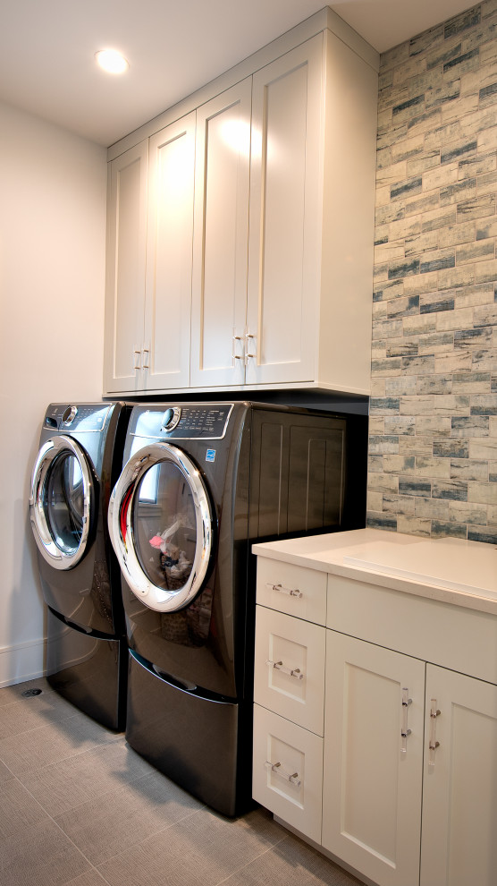 Design ideas for a small contemporary dedicated laundry room in Chicago with an integrated sink, shaker cabinets, white cabinets, quartz benchtops, blue splashback, porcelain splashback, white walls, ceramic floors, a side-by-side washer and dryer, grey floor and white benchtop.