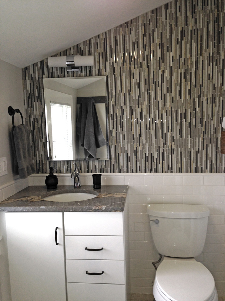 This is an example of a small contemporary bathroom in Boston with a vessel sink, flat-panel cabinets, white cabinets, laminate benchtops, an alcove shower, a two-piece toilet, brown tile, green walls and porcelain floors.