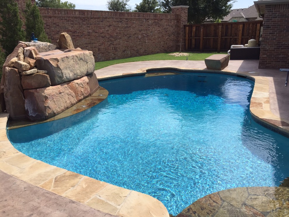 Photo of a medium sized world-inspired back custom shaped natural swimming pool in Oklahoma City.