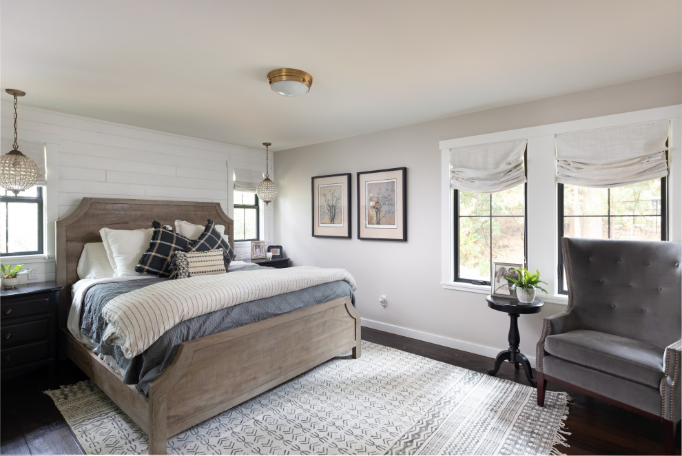 Inspiration for a large country master bedroom in Seattle with beige walls, dark hardwood floors and brown floor.