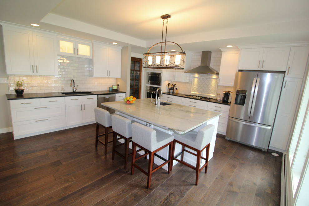Kitchen - kitchen idea with an undermount sink, shaker cabinets, white cabinets, quartzite countertops, subway tile backsplash, stainless steel appliances and an island
