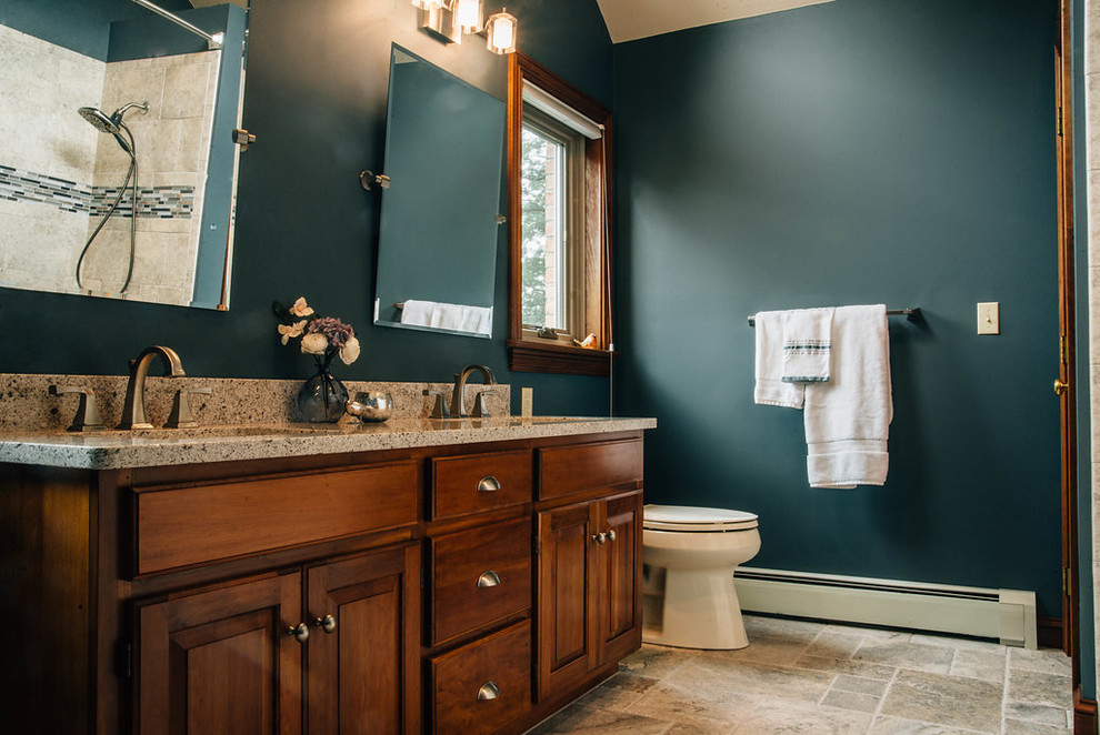 Photo of a mid-sized transitional master bathroom in Other with raised-panel cabinets, dark wood cabinets, an alcove tub, a shower/bathtub combo, beige tile, travertine, green walls, travertine floors, an undermount sink, granite benchtops, beige floor, a shower curtain and grey benchtops.