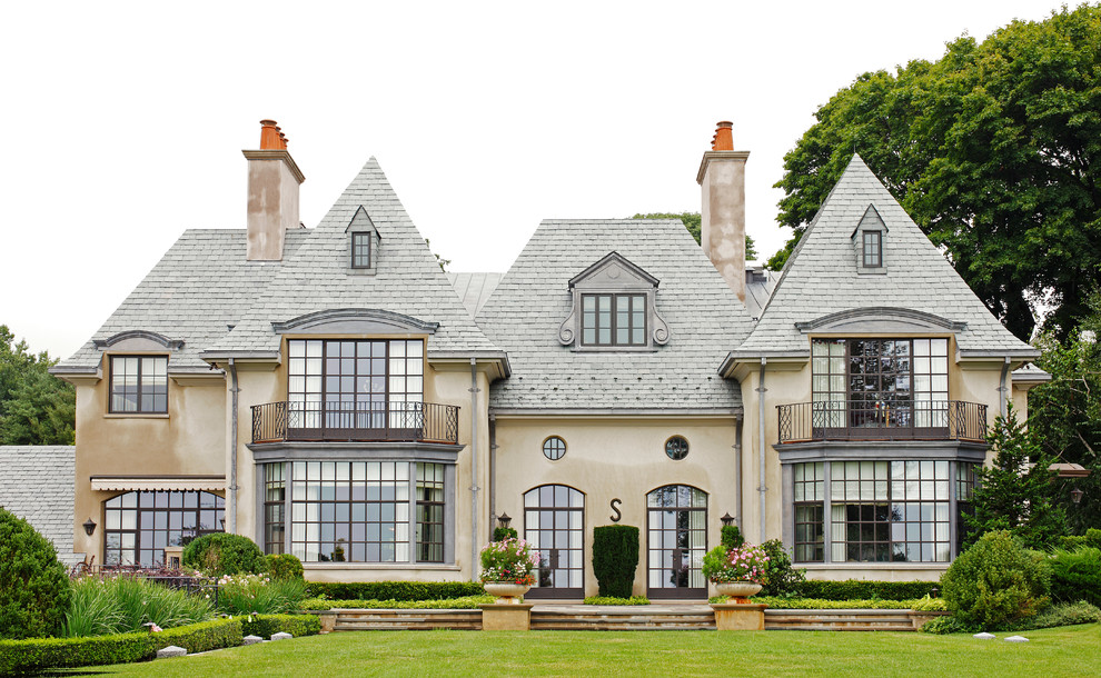Example of a huge classic beige three-story exterior home design in Atlanta with a hip roof