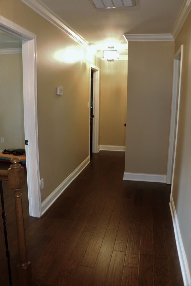 Inspiration for a mid-sized transitional dark wood floor and brown floor hallway remodel with beige walls