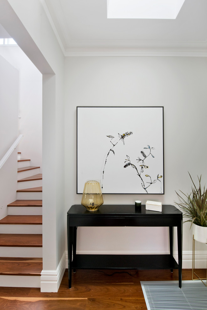 Mid-sized transitional hallway in Sydney with grey walls and brown floor.
