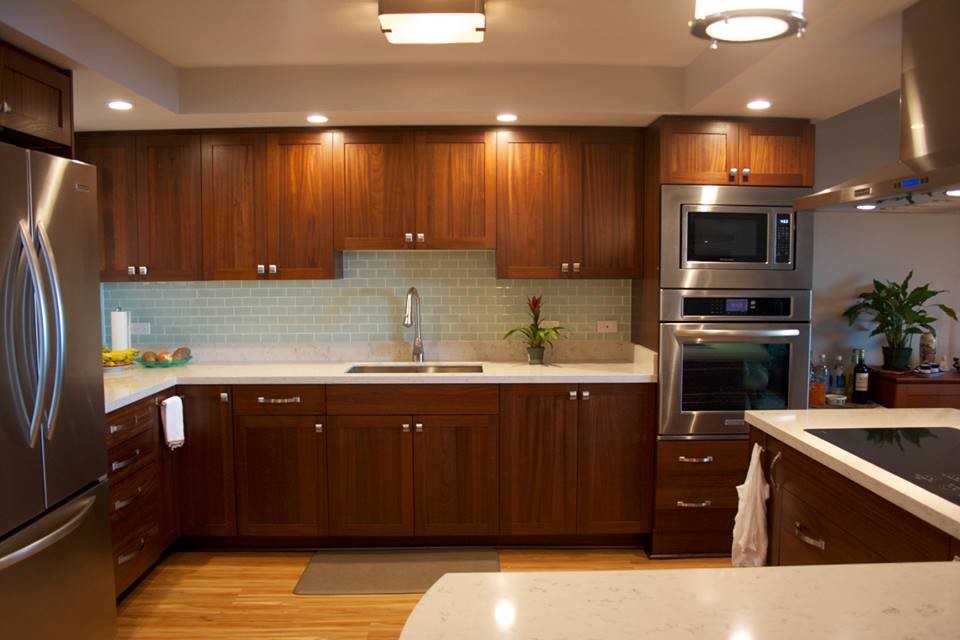 Inspiration for a large transitional l-shaped light wood floor eat-in kitchen remodel in Houston with a drop-in sink, shaker cabinets, medium tone wood cabinets, quartzite countertops, blue backsplash, glass tile backsplash, stainless steel appliances and an island