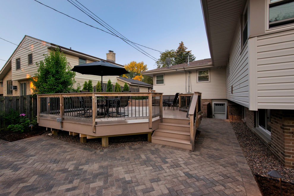 This is an example of a small traditional backyard deck in Milwaukee with no cover.