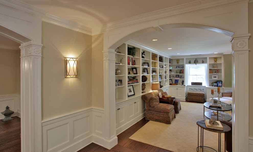 This is an example of a large contemporary foyer in DC Metro with beige walls, dark hardwood floors and a single front door.