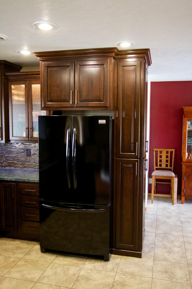 Open concept kitchen - mid-sized u-shaped open concept kitchen idea with an undermount sink, laminate countertops, multicolored backsplash, matchstick tile backsplash, black appliances, an island and dark wood cabinets