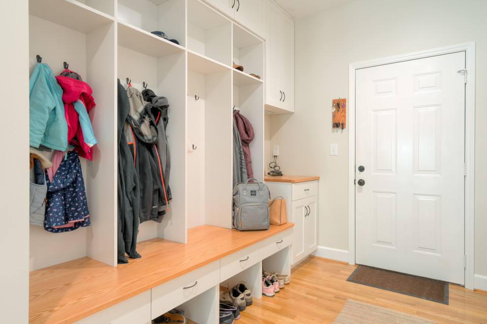 Inspiration for a mid-sized transitional light wood floor mudroom remodel