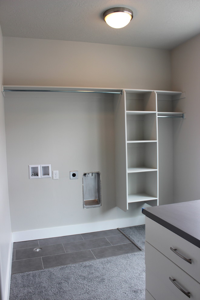 Photo of a large arts and crafts gender-neutral dressing room in Salt Lake City with open cabinets, white cabinets and carpet.